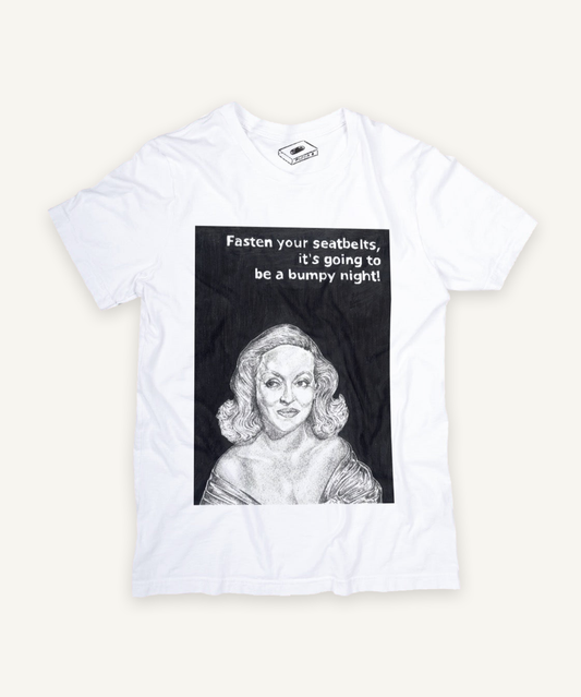 all about eve T-shirt on ivory background with natural shadow